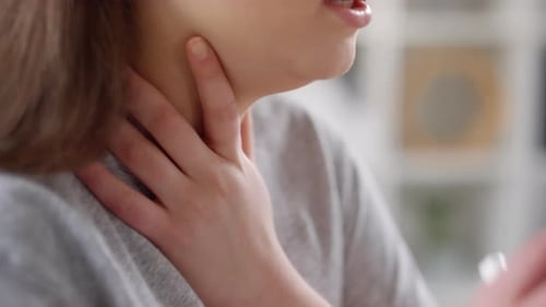 Woman Uses Inhaler For Asthma Relief Close Up