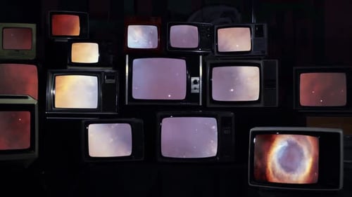 Assorted Vintage Televisions Displaying Static and Nebula Images