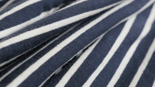 Blue and white striped fabric close-up 4K 2160p 30fps UltraHD tilting footage - Sailor marine cloth