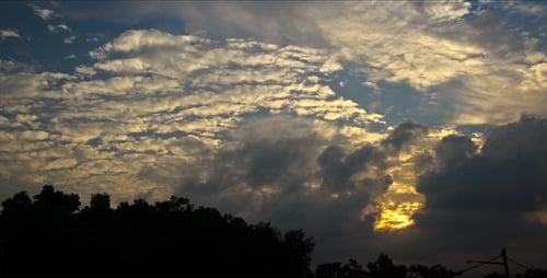 Vibrant Sunset Time-Lapse with Ascending Sun and Clouds
