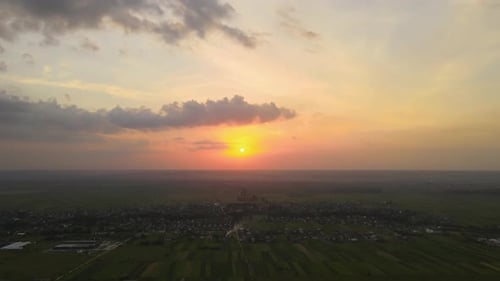 Aerial Landscape View of Village Houses and Distant Green Cultivated Agricultural Fields with
