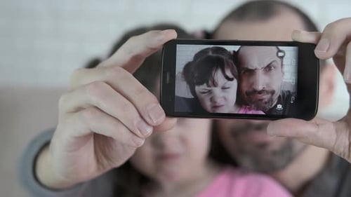 Father and Daughter Taking a Selfie Together