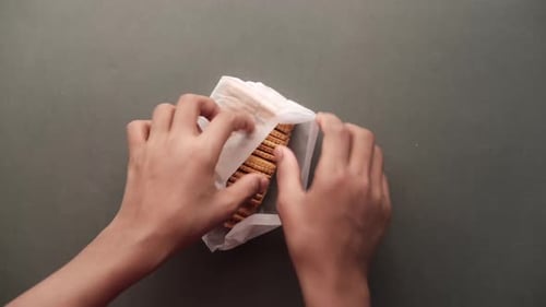 Close Up of Open a Packet of Sweet Cookies