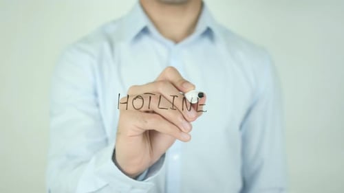 Writing Hotline Word with Marker on Clear Surface