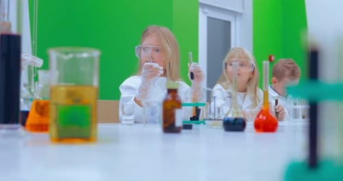 Children Studing Chemistry in School Laboratory