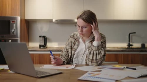 Thoughtful Woman with Glasses Working on Financial Documents Concept of the Student Learning Process