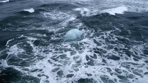 Iceberg Floats in Wavy Ocean Waters