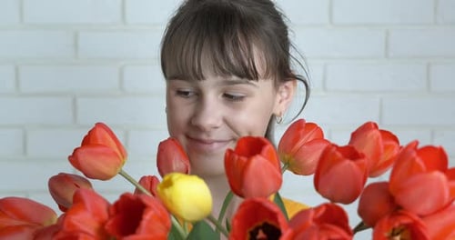 Happy Child with Fresh Tulips Bouquet