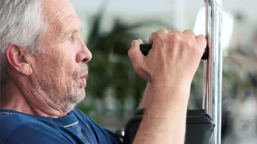 Close Up Old Man Doing Chest Exercise at Gym