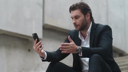 Business Man Talking Online with Client on Street. Male Manager Using Smartphone