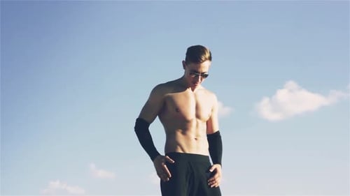 Attractive Shirtless Man Posing Outdoors on Sunny Day