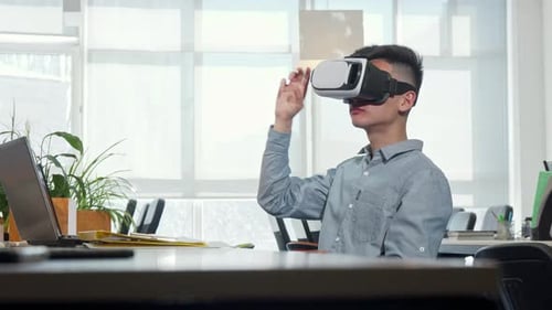 Young Man Using Virtual Reality Headset in Office