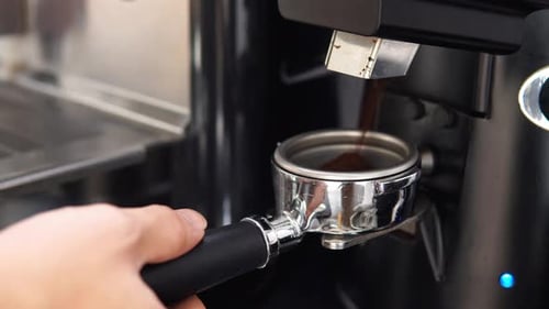 Coffee Grinds Falling into a Coffee Filter