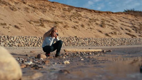 Woman Taking Picture on a Beach