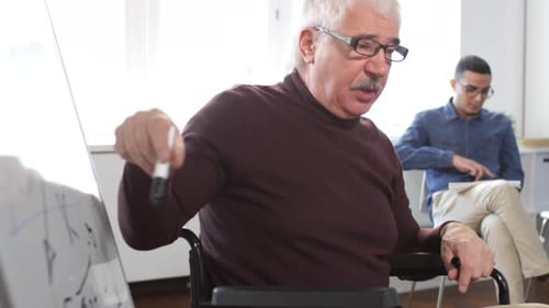 Man in Wheelchair Leads Group Discussion