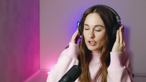 Close Up of Podcast Presenter or DJ Talking on the Microphone Female in the Studio Reading a Text