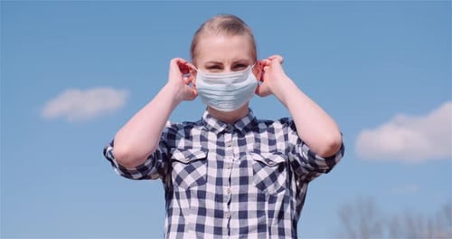 Woman Wearing Protective Mask Against Clouds Background