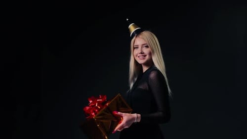 Woman Holding a Gift and Smiling