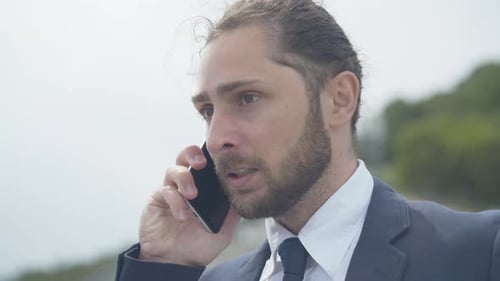 Close-up of Aggressive Man Shouting in Smartphone. Portrait of Angry Nervous Caucasian Businessman