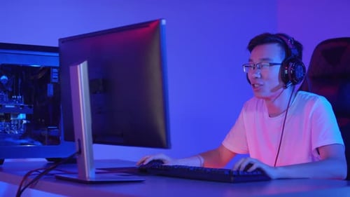 Young Adult Gaming at Computer at Home