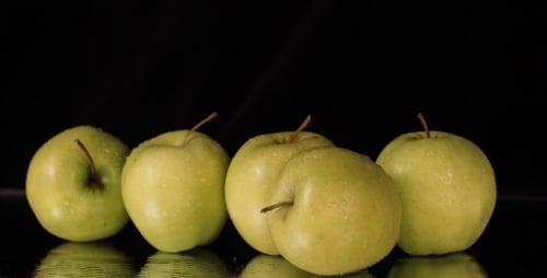 Fresh Green Apples Rotating On Black