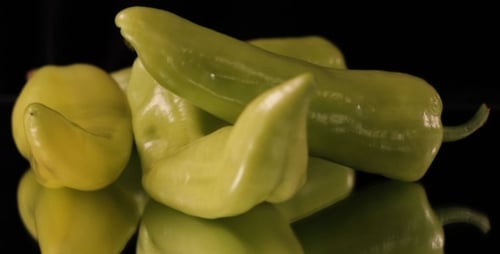 Fresh Green Peppers Rotating On Black Background