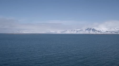 Snowy Mountains Meet Blue Ocean Waters