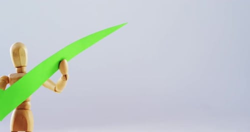 Figurine holding correct sign