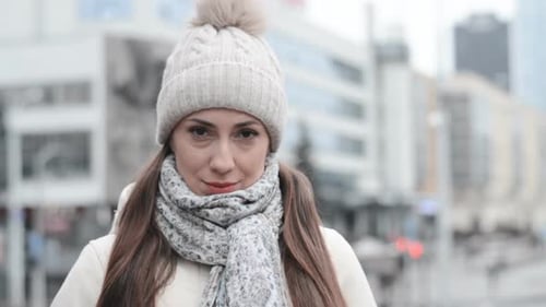 Woman in Winter Hat Standing Outside in City