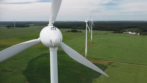 Aerial View of Spinning Wind Turbines on Farmland
