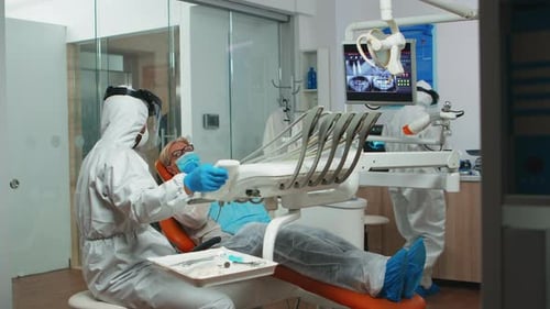 Dentist Doctors Examining Patient in Protective Gear