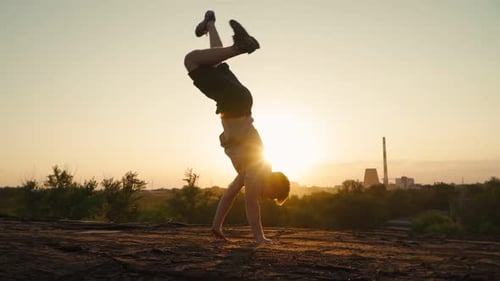 Young Adult Performs Acrobatics During Golden Hour