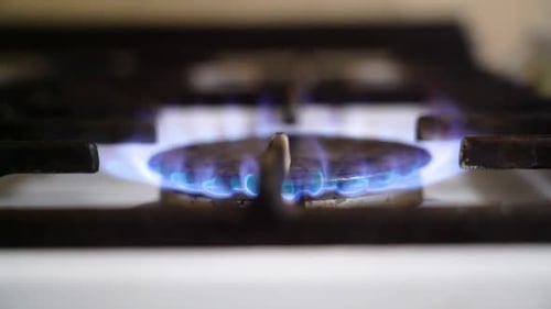 Gas Stove Burner Igniting with Blue Flame