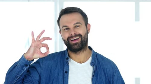 Okay Satisfied Man with Beard Sitting in Office