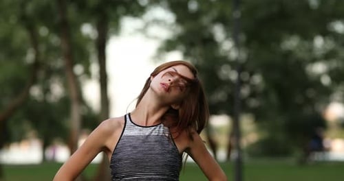 Fitness and Yoga in Nature. The Girl Is Warming Up.