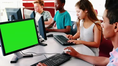 Teens Working on Computers with Chroma Key Screen