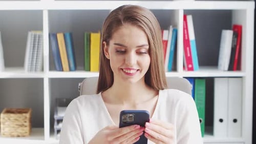 Young Woman Works at Home Office Using Computer.