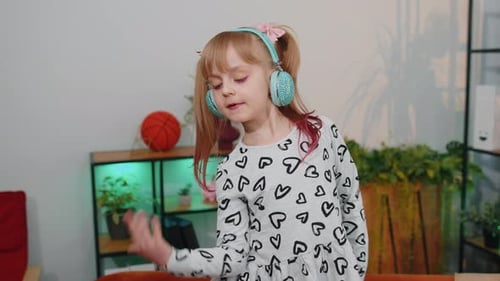 Girl with Headphones Singing and Dancing Indoors