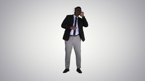 Man in Blazer Dances to Music on Headphones