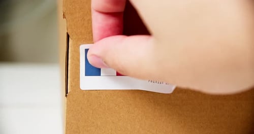 Applying a Label to a Cardboard Box