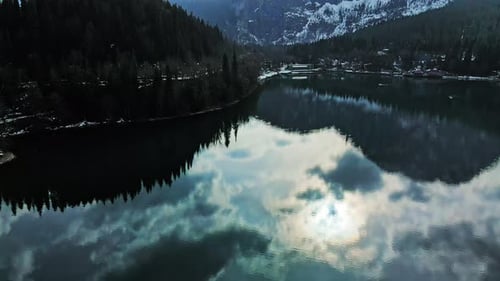Clear Blue Mountain Lake with Reflection of Clouds on the Water