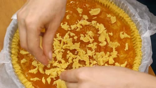Hands Crumbling Dough on Sweet Pie for Baking