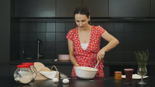 Woman Mixing Batter in Kitchen with Spatula
