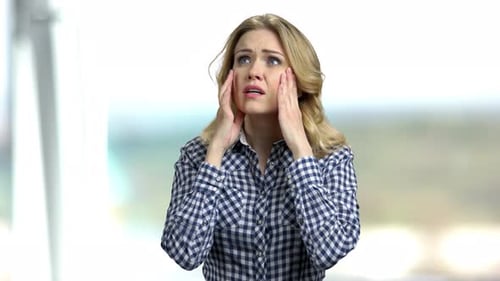 Woman Rubbing Temples with Sad Expression