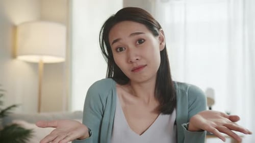 Woman Gesturing and Shrugging Indoors