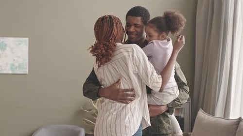 Soldier Returns Home, Embraces Wife and Daughter