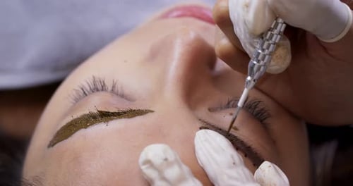 Close up of cosmetologist making microblading procedure