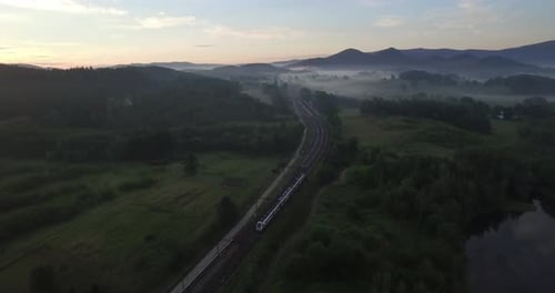 Scenic Aerial View of Train Traveling Through Countryside