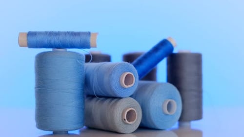 Blue and Gray Sewing Thread Spools Close Up