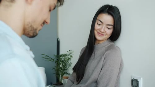 Affectionate Couple Sharing a Snack at Home